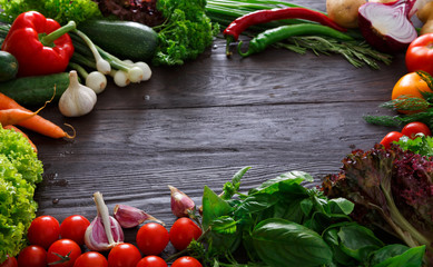 Frame of fresh vegetables on wooden background with copy space