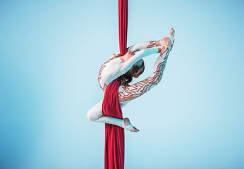Graceful gymnast performing aerial exercise