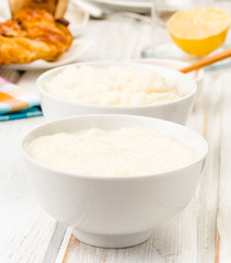 brimming bowls of rice pudding, on wood