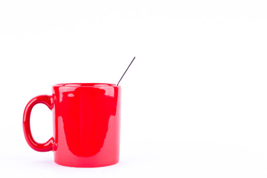 red coffee or tea or milk mug cup and spoon on white background drink isolated
