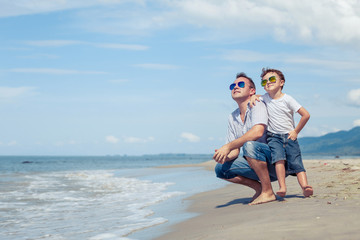Father and son playing on the beach at the day time.