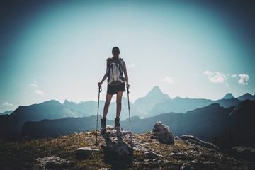 Vignette of hiker with poles near summit