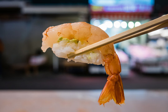 Prawn sushi with chopstick