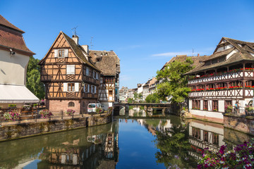 Fototapeta na wymiar Strasbourg, France. The picturesque landscape with reflection in the water of buildings in the neighborhood 