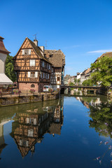 Fototapeta na wymiar Strasbourg, France. The picturesque landscape with reflection in the water of buildings in the old quarter 