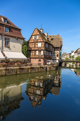 Fototapeta na wymiar Strasbourg, France. The picturesque landscape with reflection in the water of old buildings in the historic quarter 