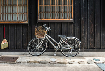 Bicycle on vintage wooden house wall