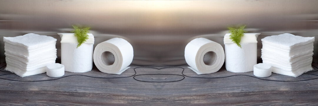 White kitchen paper towel, toilet paper, paper tissue, napkins on a dark wooden table. Wide panorama

