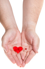 two red hearts on male palms isolated on white
