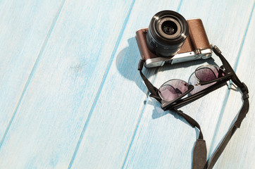 top view of retro style camera on blue wooden table