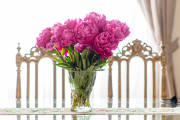 Shiny and reflective dining room table by chair