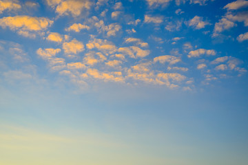 Pretty fluffy orange clouds in a sunset sky