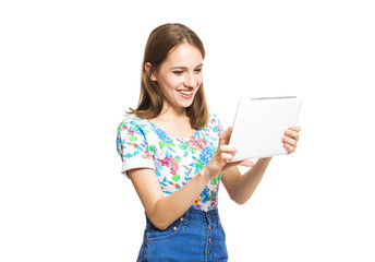 Funny young girl with a tablet isolated on white background.