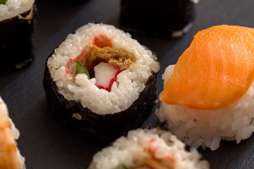 Salmon sushi roll with snow crab and cucumber. Macro. Photo can be used as a whole background.