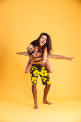 Young happy couple enjoying piggyback ride