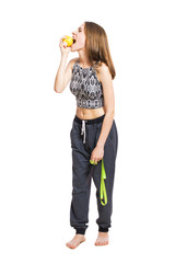 Fototapeta na wymiar Young cheerful woman in a home clothes with a measuring tape and apple isolated on white background. Concept of diet and weight loss.