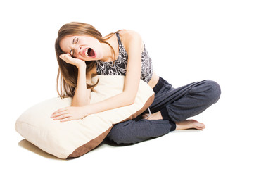 Obraz premium Artistic young girl with a pillow isolated on white background.
