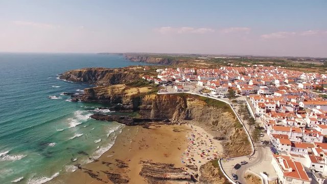 Panoramic view of Zambujeira de Mar and beach with holidaymakers people aerial view
