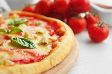 Delicious pizza on wooden cutting board