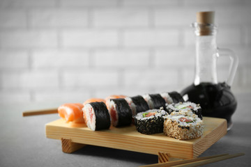 Delicious sushi rolls on table
