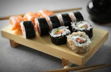 Delicious sushi rolls on table