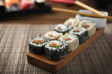 Delicious sushi rolls on table