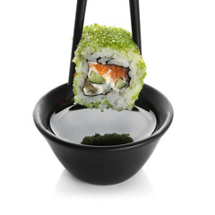 Delicious sushi roll with soy sauce, isolated on white