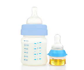 Feeding bottle with baby milk formula and bottle with medicine on white background