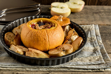 Whole baked pumpkin on plate 