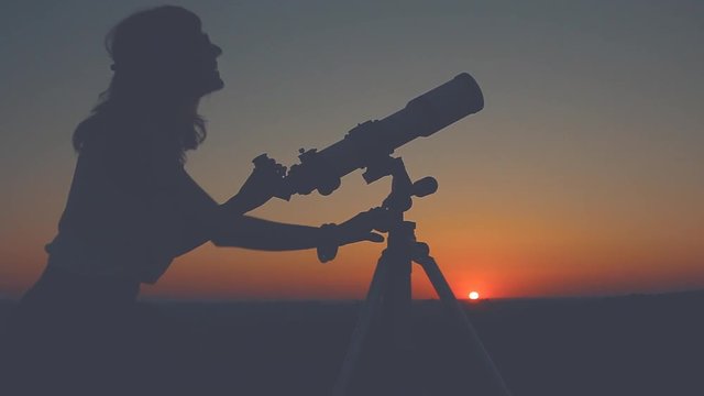Girl stargazing with a telescope.
