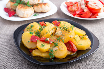 Stewed potatoes, meatballs of minced meat and tomato salad
