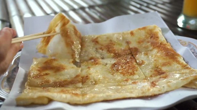 Close up shot of Thai popular street food, sweet crispy pancake roti serving in plate
