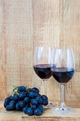 Fresh grape and red wine on the vintage table, selective focus