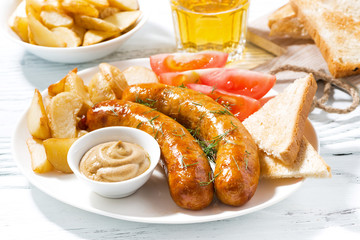 fried sausages with potatoes and mustard