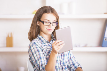 Young woman using digital pad