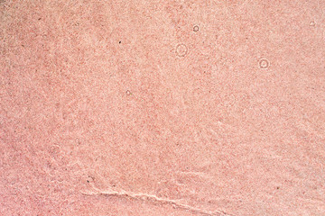 background of pink sand on the beach