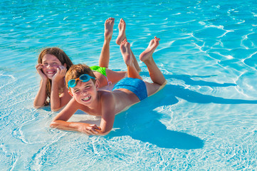 Two children lying on the beach