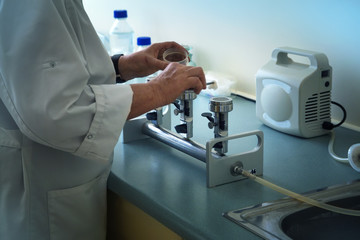 Medical laboratory assistant works with Burner in laboratory