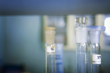 Background of long flasks and laboratory test tubes in laboratory