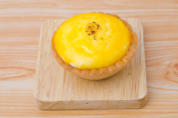Egg tart on wooden plate