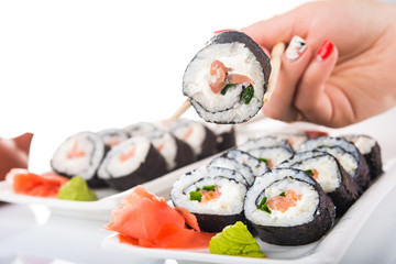 woman holding sushi roll