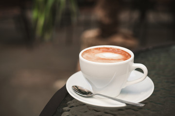 White cup of coffee on a table