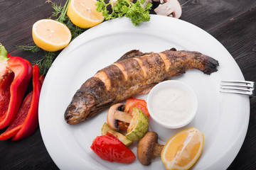 baked fish with lemon and grilled vegetables