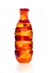 Bottle made from sliced nectarine on white