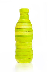 Bottle made from green sliced apples on white