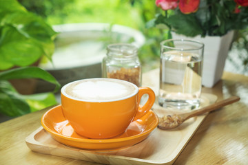 Cup of coffee on the table in the garden