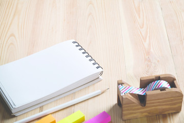 Office desk table with Notebook,clock and supplies