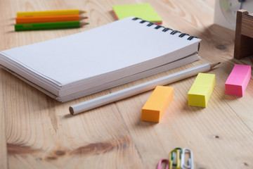 Office desk table with Notebook,clock and supplies