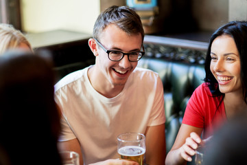 happy friends drinking beer at bar or pub