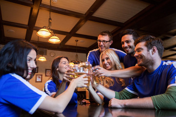 football fans clinking beer glasses at sport bar